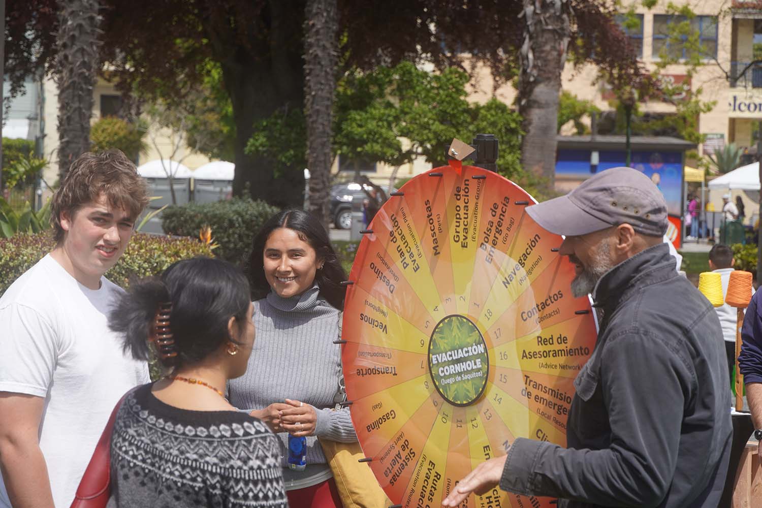 Community members playing the Prototyping Resilience evacuation board game at a community event